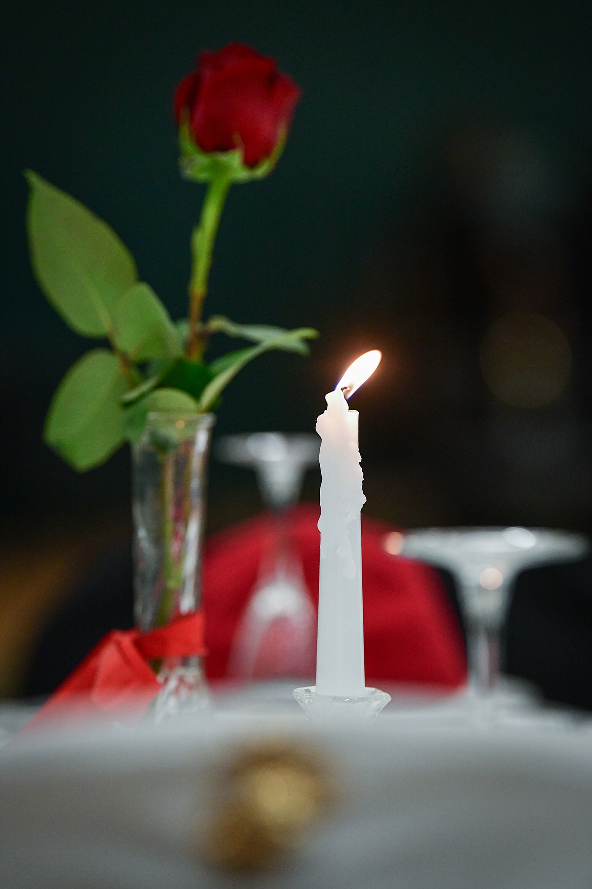 A candle and red rose sit  atop The Missing Man Table at the Veterans Day Community Event at Whitefish High School on Thursday, Nov. 9. The Missing Man Table was dedicated to the 359 servicemen still missing from the Battle of Tarawa, a three-day battle in November 1943 where 1,020 United States servicemembers lives were lost. The candle's flame and the rose serve as reminders of the lives of each of the missing and their loved ones who keep the faith. (Casey Kreider/Daily Inter Lake)