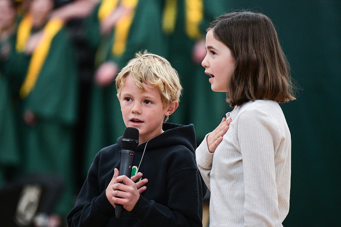 Muldown Elementary School students Simon Binford and Mikaela Woomer recite the Pledge of Allegiance to the audience at the Veterans Day Community Event at Whitefish High School on Thursday, Nov. 9. (Casey Kreider/Daily Inter Lake)