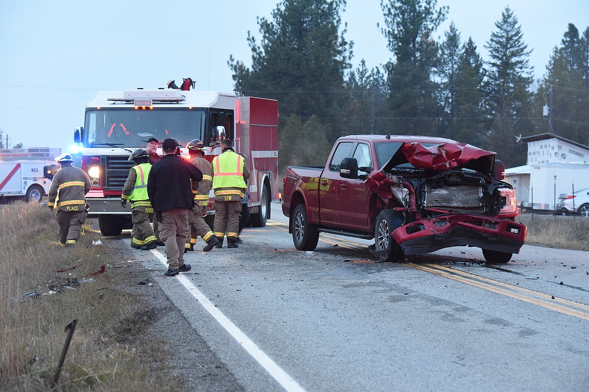 Lincoln County first responders from Rural Fire District 1, Libby Volunteer Ambulance and the Sheriff's Office work at the scene of a 2-vehicle accident Thursday evening on U.S. 2 at the Hammer Cutoff Road intersection. (Scott Shindledecker/The Western News)