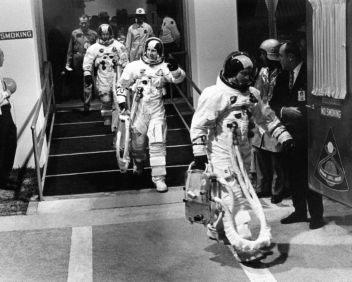 Apollo 8 astronauts, suited up and ready to go, walk to a van heading for their Saturn V rocket for their moon orbit mission from Cape Kennedy, Fla., Dec. 21, 1968. Leading the way is Commander Frank Borman, followed by James A. Lovell and William A. Anders. Borman, who commanded Apollo 8's historic Christmas 1968 flight that circled the moon 10 times and paved the way for the lunar landing seven months later, has died. He was 95. Borman died Tuesday, Nov. 7, 2023, in Billings, Mont., according to a NASA statement Thursday, Nov. 9. (AP Photo/File)