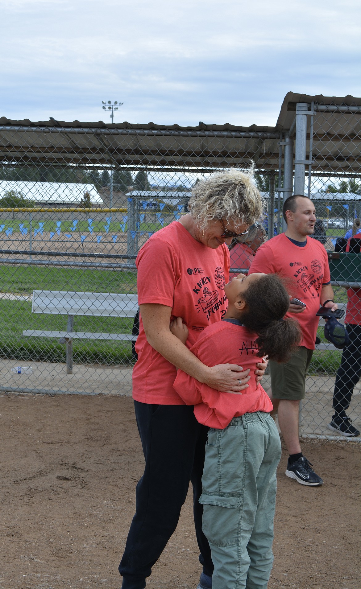 Monica Zylstra and Abby Zylstra celebrate their win with a hug after the Ladder Legends real Estate team scored 1-0 over Windermere Real Estate during the Kickin' It Forward kickball tournament.