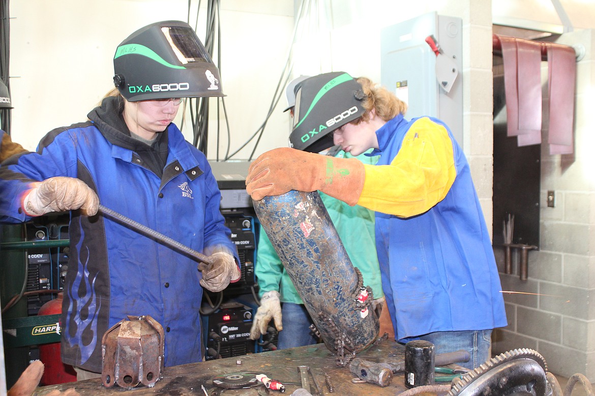 Sydney Garza and Michael Suhling try to figure out a support structure for their sculpture