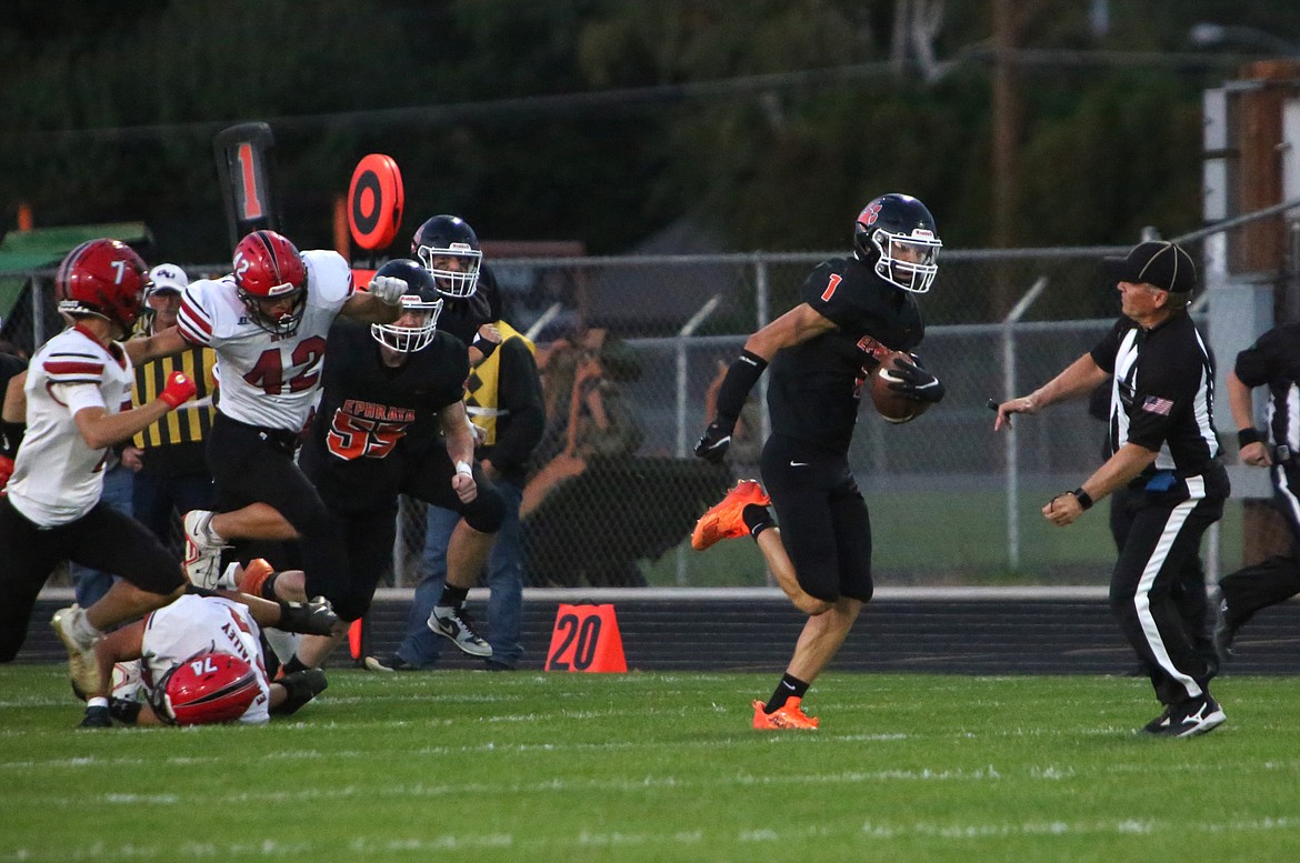 Ephrata senior Hans Roberts slips past the East Valley (Yakima) defense during a game against the Red Devils on Sept. 22.