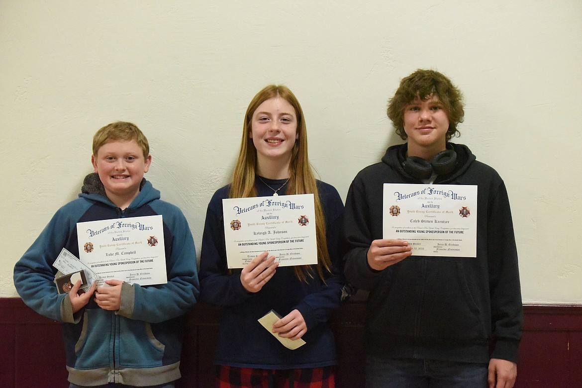 Troy Junior High students, from left, Luke Campbell, Kyleigh Johnson and Caleb Kreutzer, display the certificates they received from the Troy VFW Post 5514 on Friday, Nov. 10, at a Veterans Day ceremony for the essays they wrote. (Scott Shindledecker/The Western News)