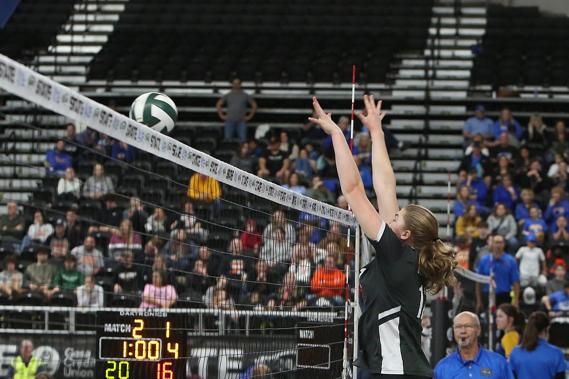 Almira/Coulee-Hartline senior Mariah McWalter jumps up with her arms raised to attempt a block.