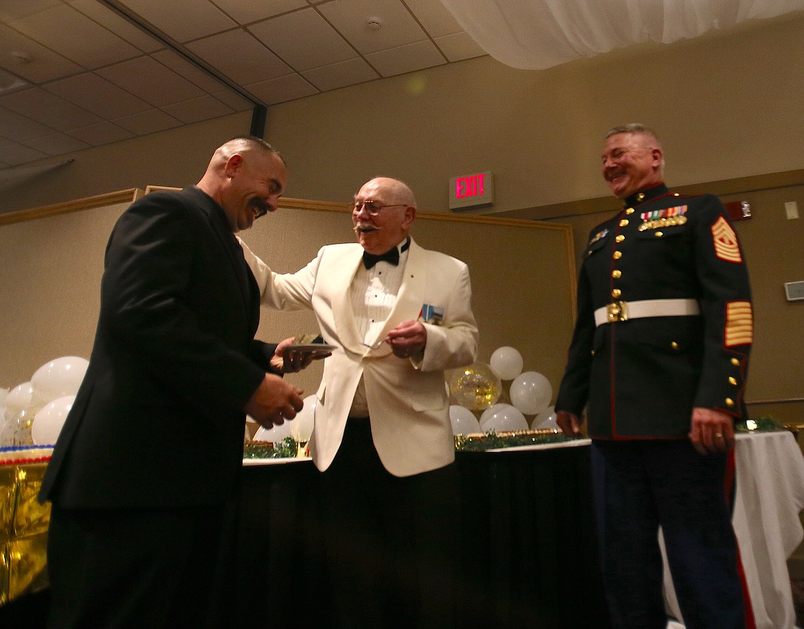 Roy Kisner, 88, delights at making Richard Walton, 39, laugh Friday night as the two are the oldest and youngest Marines at the Marine Corps Birthday Ball. The evening's guest speaker, Master Gunnery Sgt. Jay Lillefloren, right, also got in on the fun.