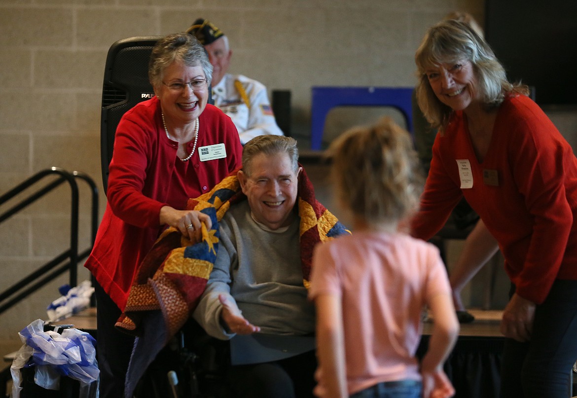 Vietnam veteran Bob Doyle receives a surprise visit from his friend's great-granddaughter, Kami Gravelle, 7, during a Quilts of Valor ceremony Friday. Also pictured: Giannine O’Connor, left and Kathy Whetstine.