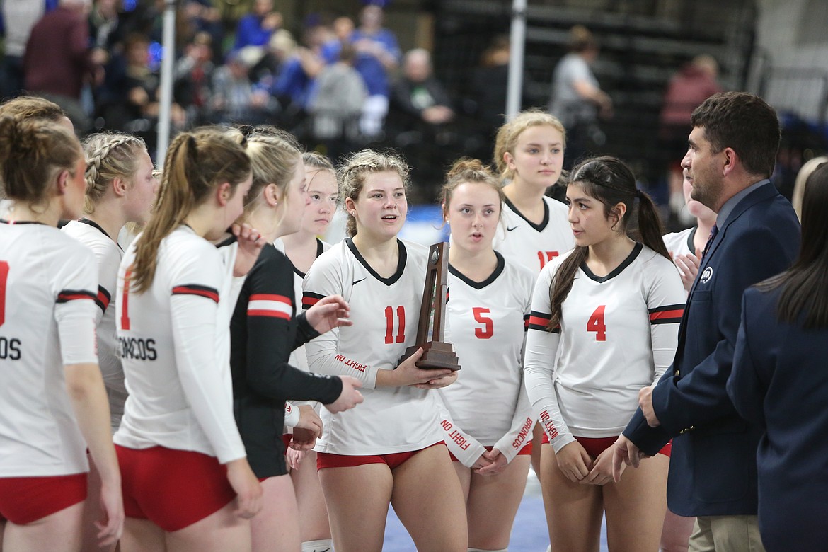 Members of the Lind-Ritzville/Sprague volleyball team are presented with the second-place trophy at the 2B State Volleyball Tournament in Yakima on Thursday.