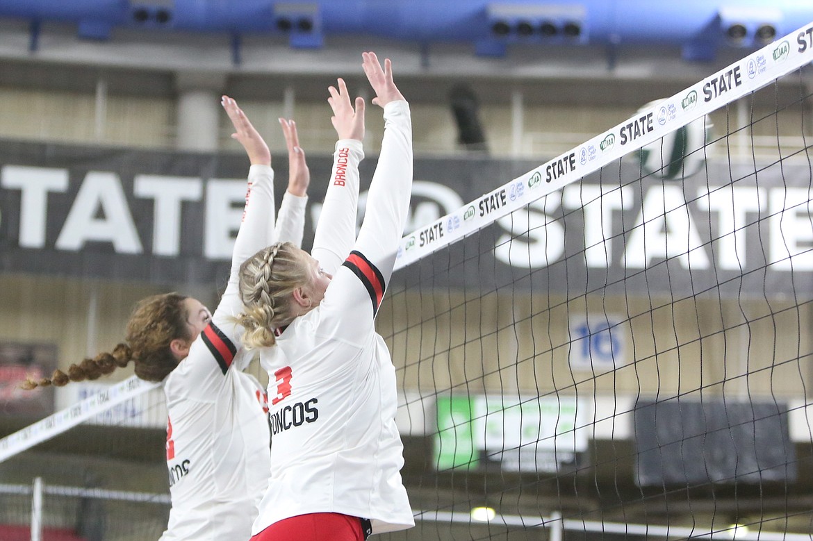 Lind-Ritzville/Sprague sophomore Sage Galbreath, left, and junior Addy Colbert, right, go up for a block against Manson.