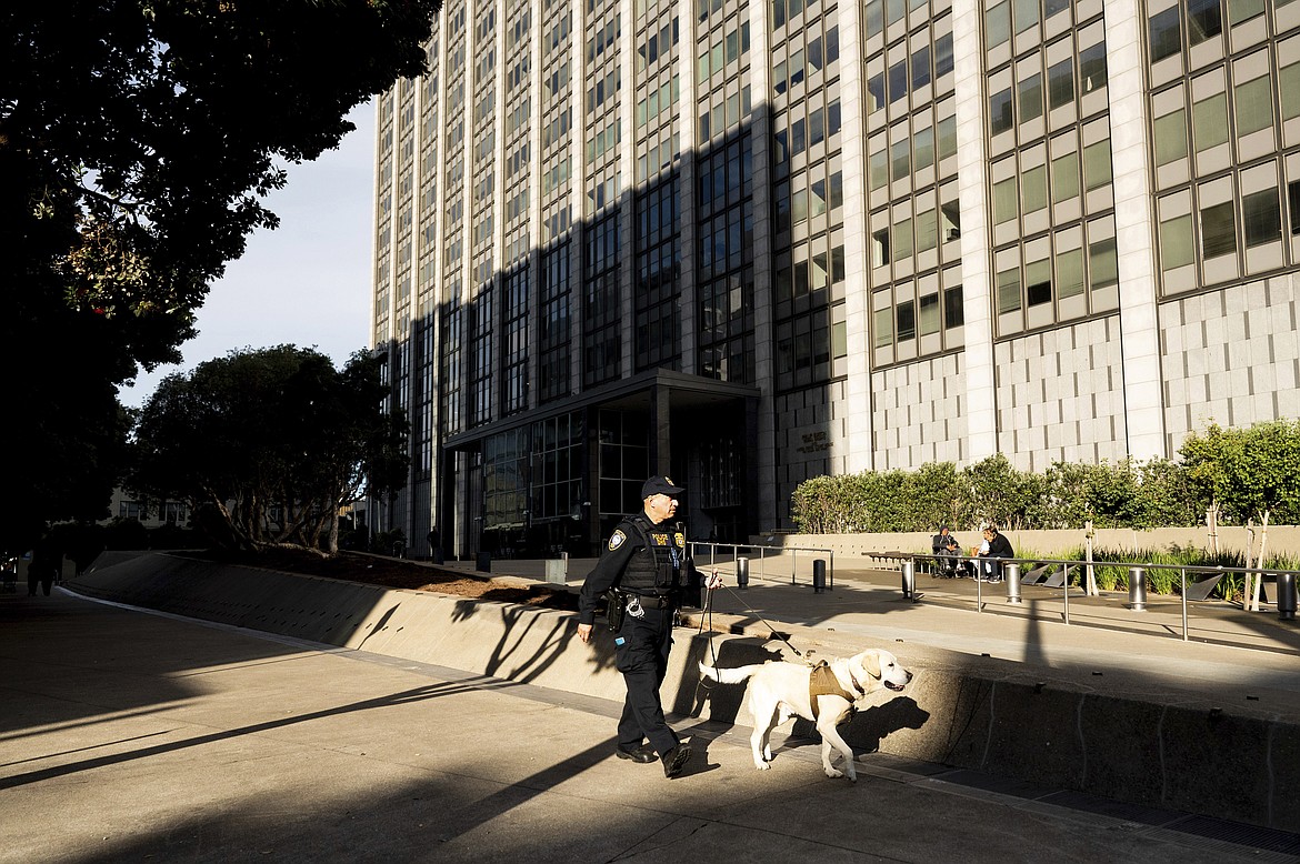 A Department of Homeland Security officer walks the perimeter of the Phillip Burton Federal Building and U.S. Courthouse where the federal trial of David DePape is underway in San Francisco, on Monday, Nov. 13, 2023. Prosecutors say DePape broke into former House Speaker Nancy Pelosi's home and bludgeoned her husband Paul Pelosi with a hammer in October 2022. (AP Photo/Noah Berger)