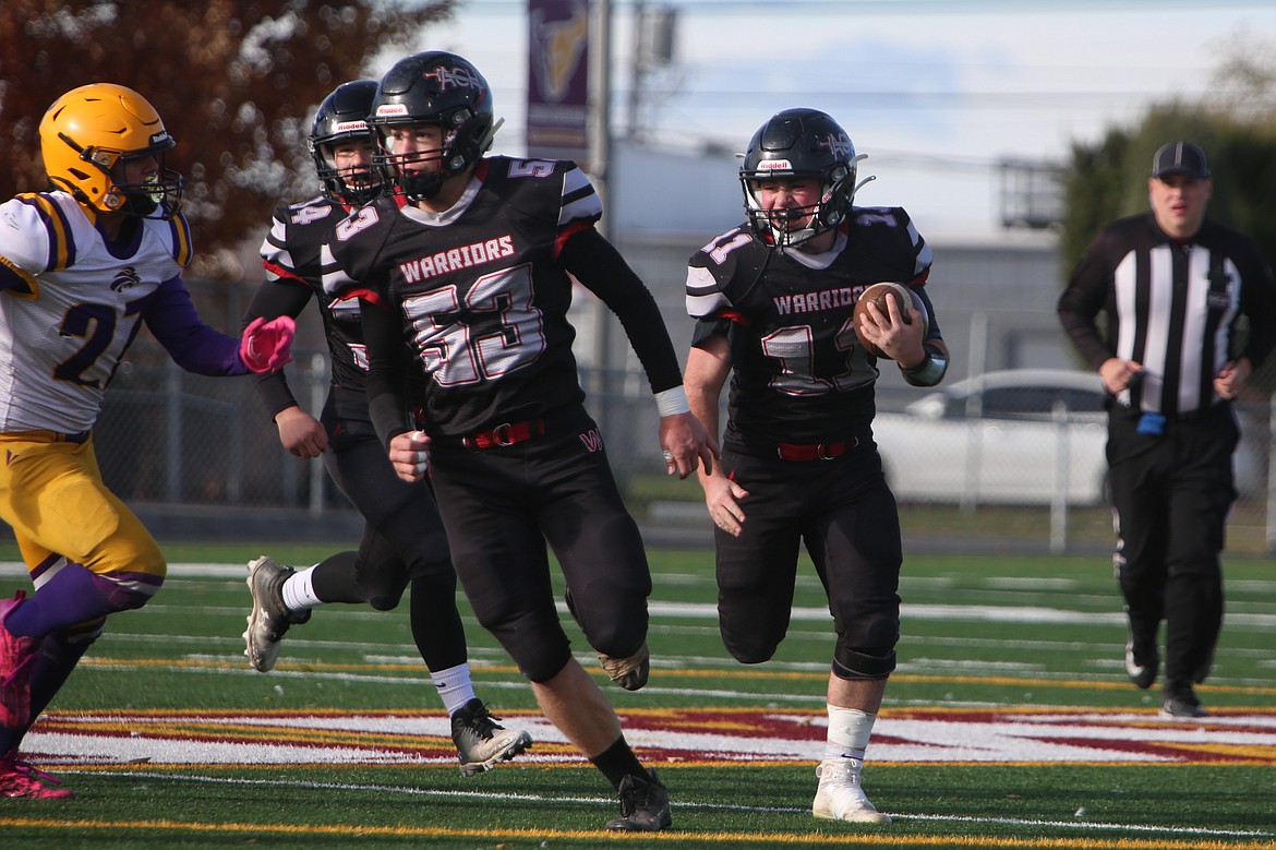 ACH junior Carter Pitts (11) follows lead blocking from seniors John Pierce (53) and Everett Wood (34) in the first quarter of the Warriors’ 42-26 win over Concrete.