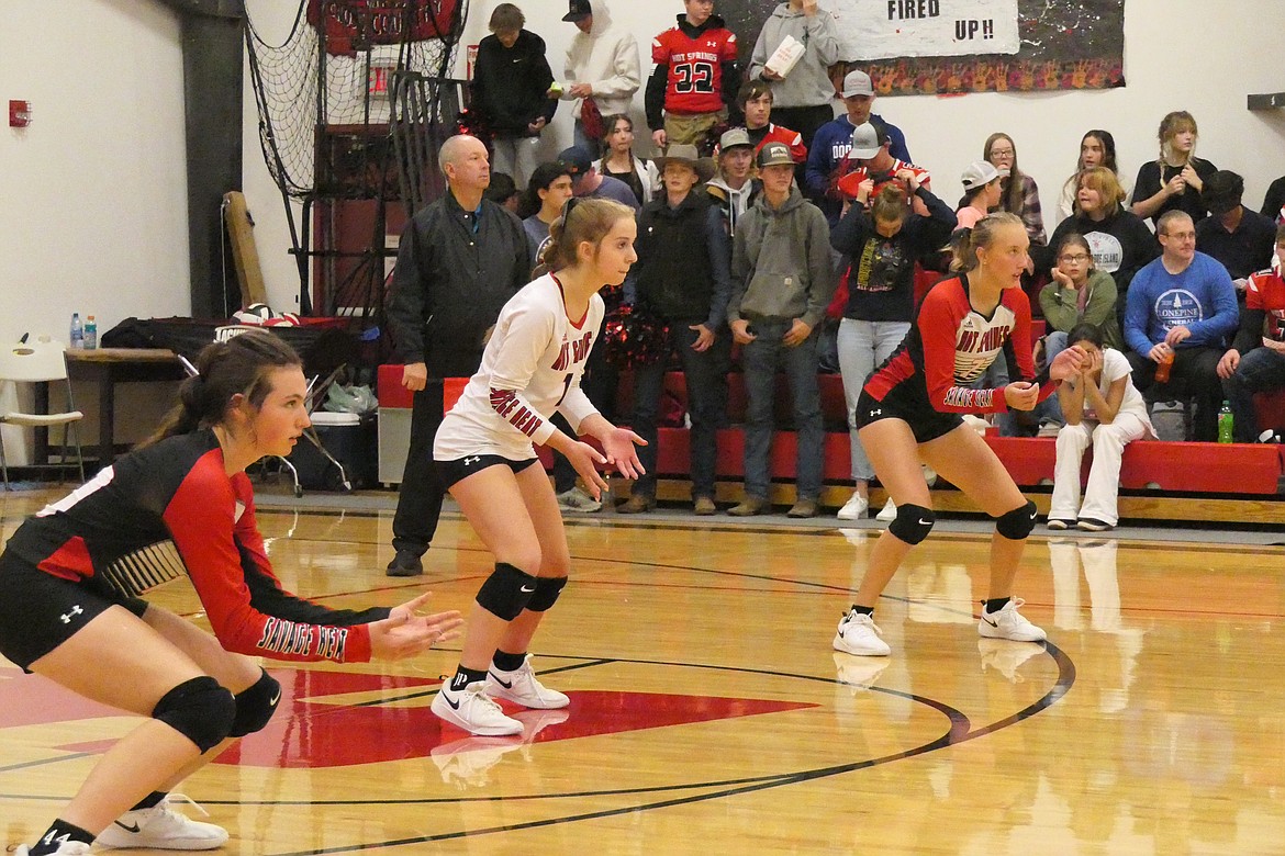 Hot Springs players (from left to right) Kara Christensen, Callie Cano, and Lauren Aldridge get ready to dig an incoming shot during post-season play in Hot Springs.  (Chuck Bandel/VP-MI)