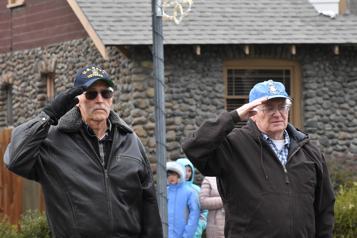 Two veterans salute at Taps is played at the Veterans Day ceremony outside the Ephrata Recreation Center Saturday.