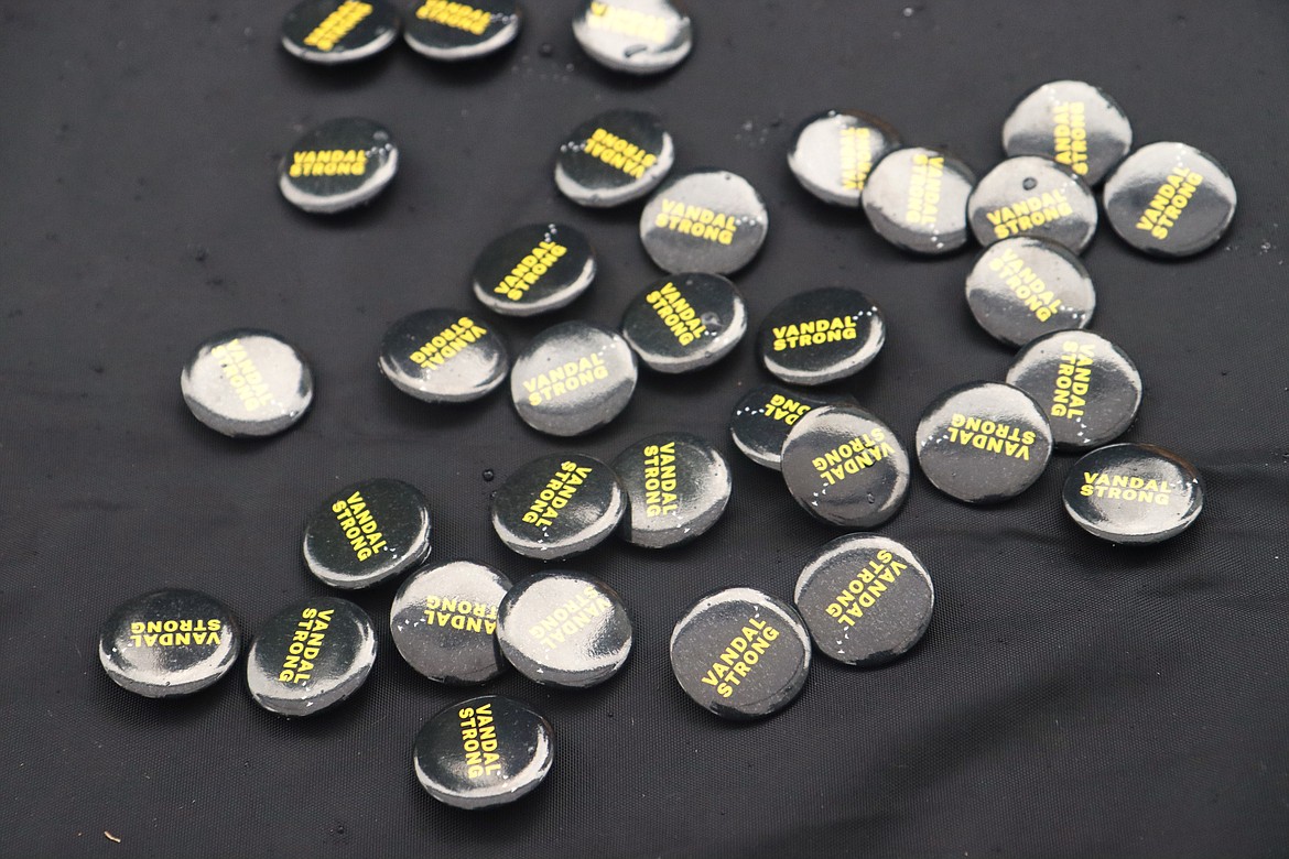 Vandal Strong buttons sit on a table at a new memorial garden at the Harbor Center sign on Hubbard Avenue on Monday.