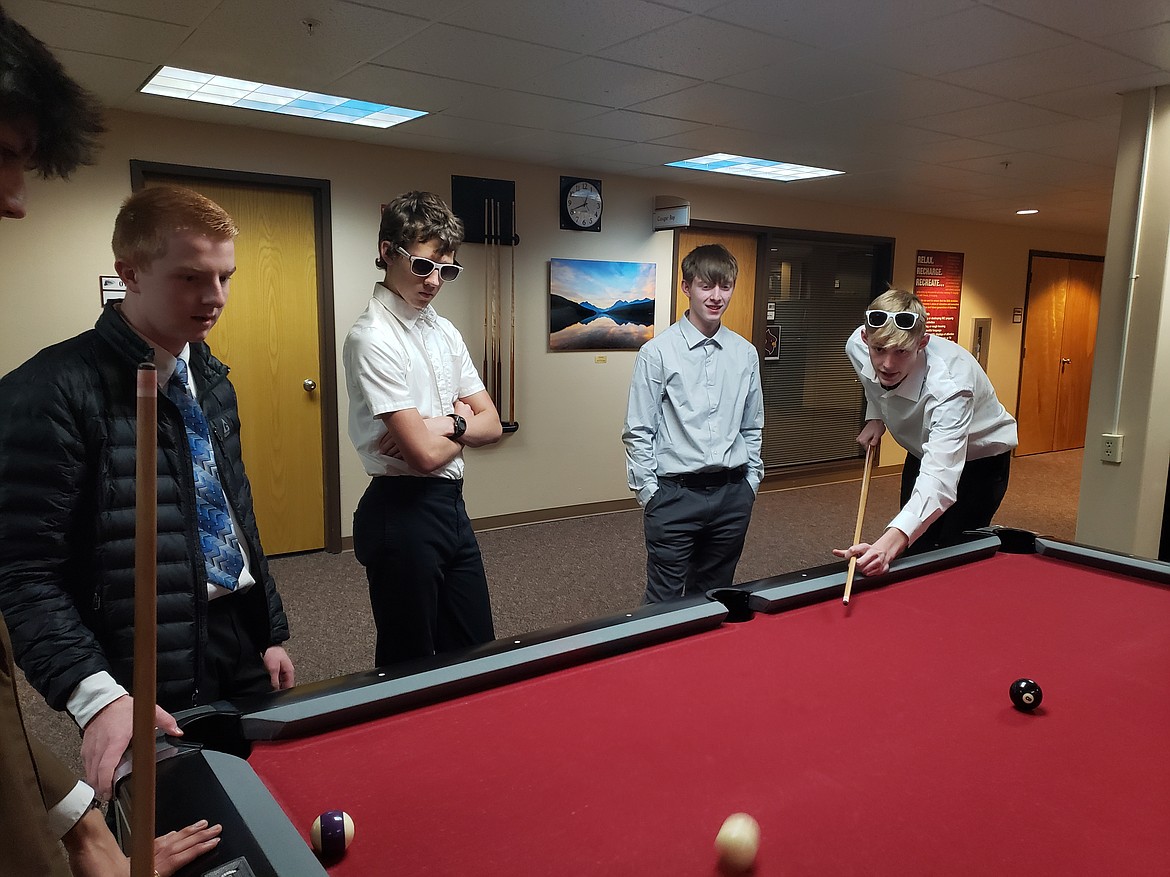 From left, Mica Collins, Alijah Freeman, Rush Gustafson and Zach Cook play a game of pool during lunch at the North Idaho College Math Contest. STEM Charter Academy senior Alijah had the highest score across both divisions in all grades.