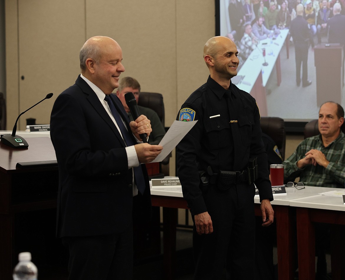 Othello Mayor Shawn Logan, standing left, swears in the Othello Police Department’s new Assistant Chief of Police Aaron Garza during Monday’s regular City Council meeting.