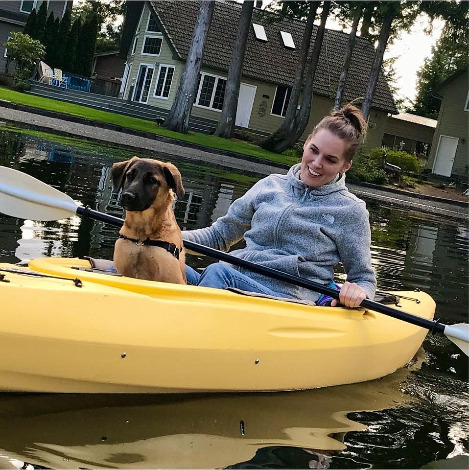 Seattle business owner Staci Molzahn kayaks with her dog, Kobe, whom she adopted from Adams County Pet Rescue. Molzahn is holding fundraisers at all four businesses she co-owns.