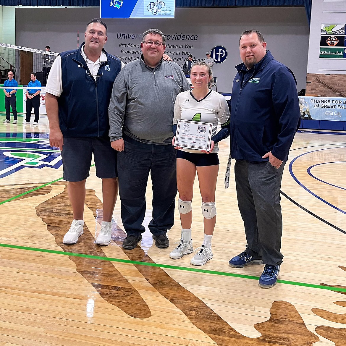 Courtesy photo
Ellie Carlson, a freshman from Lakeland High, received the NAIA Champions of Character Award during a recent match in Great Falls, Mont. From left are University of Providence athletic director Dough Hashley, Frontier Conference commissioner Scott Crawford, Carlson and Providence volleyball coach Arunas Duda.