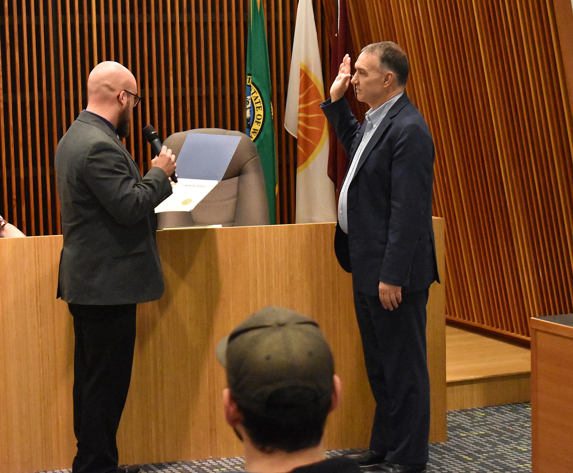 Moses Lake Mayor Don Myers, left, administers the oath of office to Kevin Fuhr, the city’s new city manager. Fuhr has been serving as interim city manager since May.