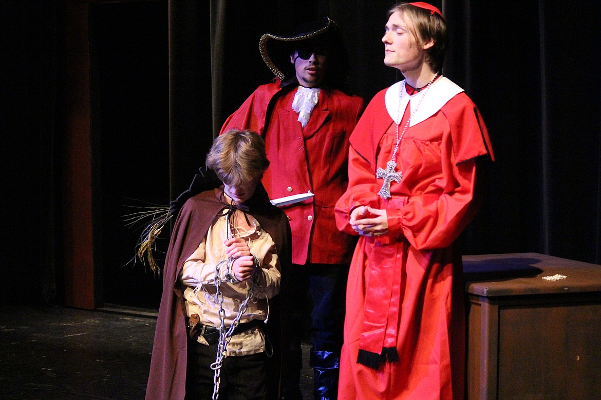 D’Artagnan (Beck Ashton, front) is brought before Richelieu (Gaige Anderson, right) in chains in the Moses Lake High School production of “The Three Musketeers.”
