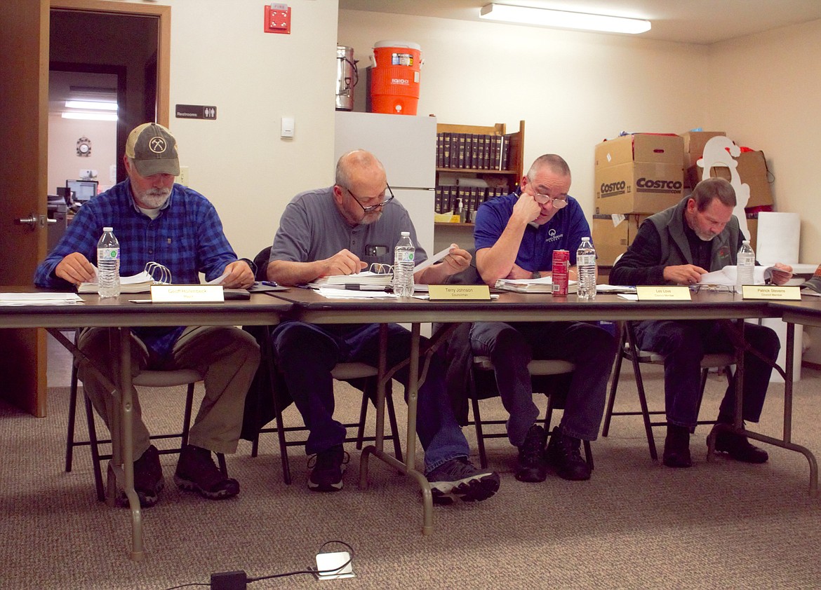 Moyie Springs city council members look over agenda items. (left) Mayor Geoff Hollenbeck, Council President Terry Johnson, Councilmen Les Love and Patrick Stevens.