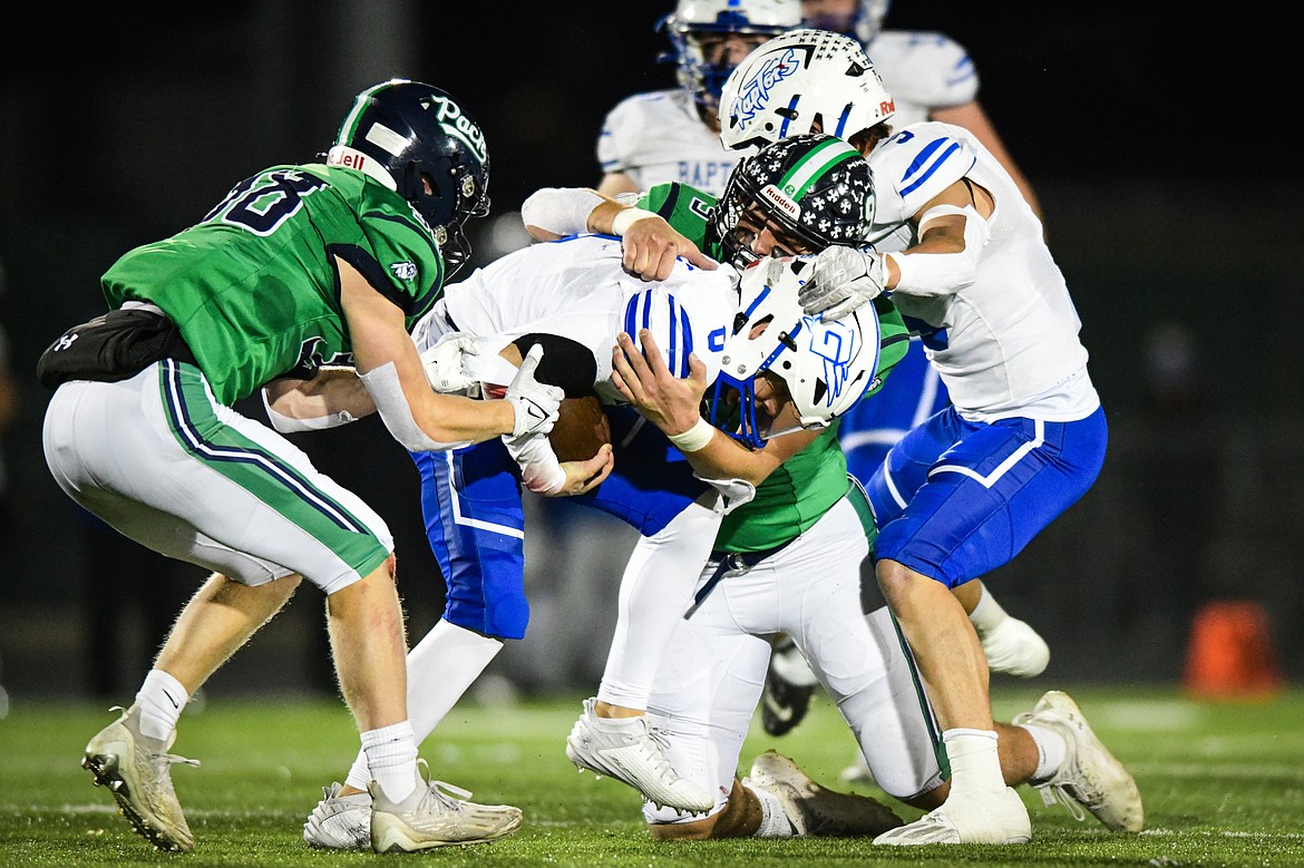 Glacier defenders Isaac Keim (9) and Carson Baker (38) stop a run by Gallatin quarterback Reese Dahlke (0) in the second quarter of the Class AA semifinals at Legends Stadium on Friday, Nov. 10. (Casey Kreider/Daily Inter Lake)