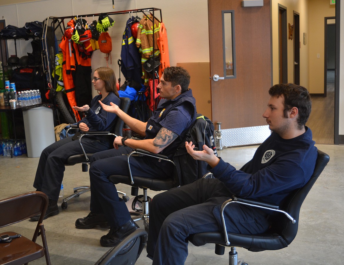 Firefighters Ashley Christmann, Victor Malsom, and explorer firefighter Jason Jurkovac participate in an exercise at a trauma, burnout, and resilience training in the Silver Valley.