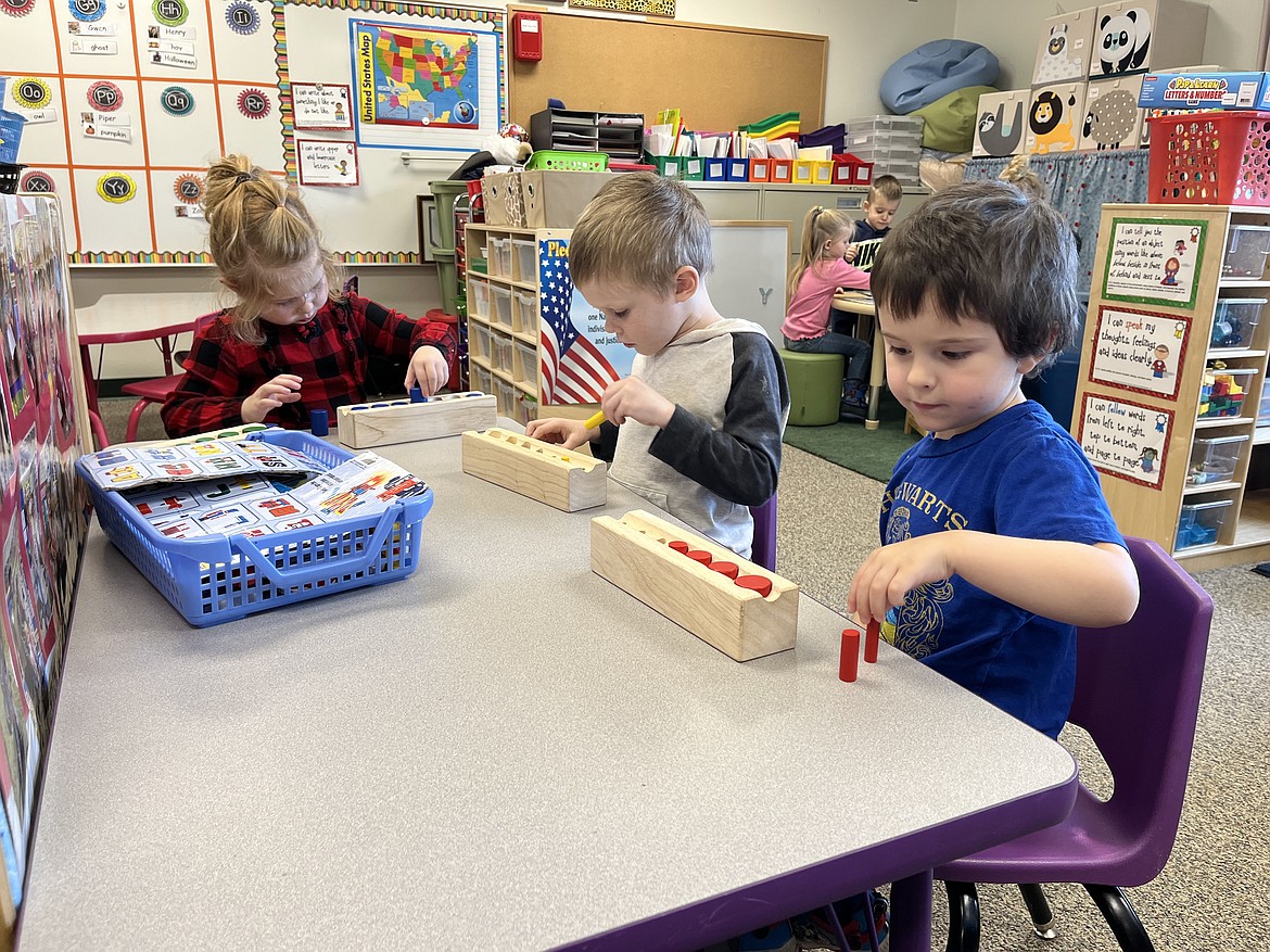 Henry Handford, Brooks Peirce and Lucy Wallace inside the Evergreen School District early kindergarten classroom. (Courtesy photo)