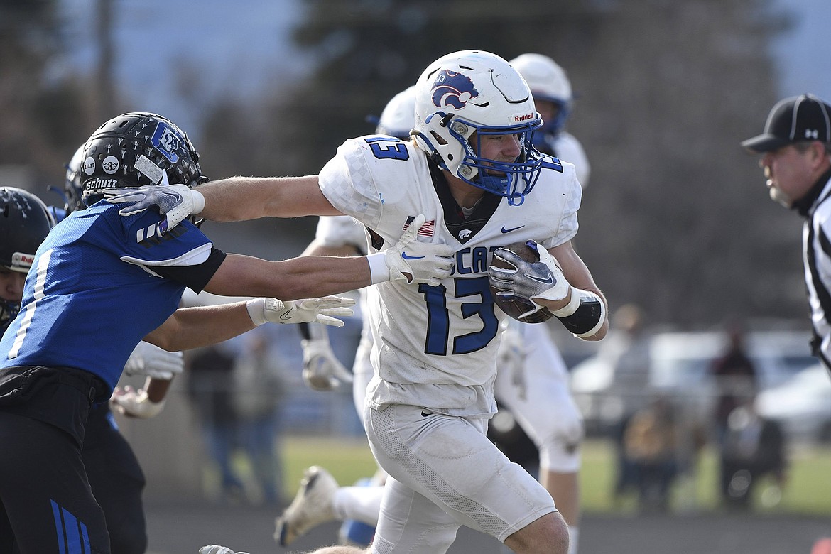 Aluhn Anderson breaks a tackle against Corvallis Saturday as the Wildcats beat the Blue Devils 19-7 in Corvallis  to advance to the state A championship game against Dillon. (Avery Howe photo)