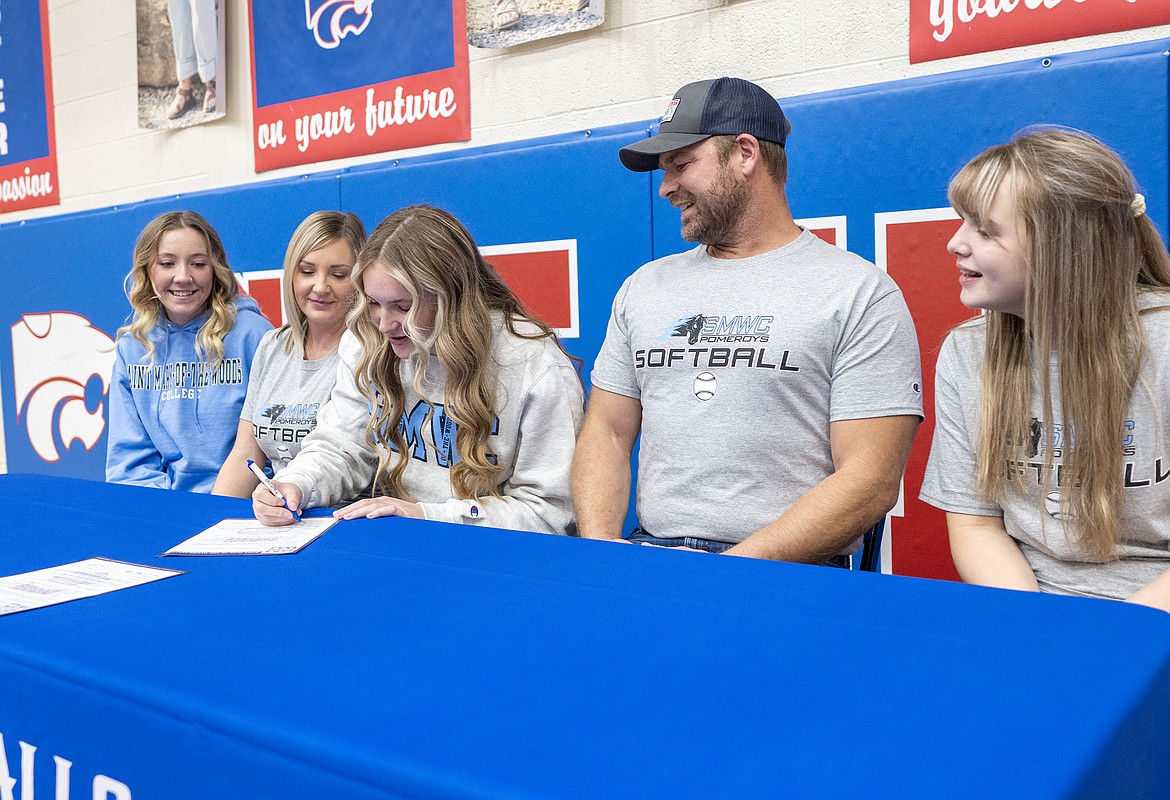 With her family looking on, Maddie Moultray officially signs to play softball with Saint Mary-of-the-Woods College on Monday. From left is sister, Shai, mom Jessica, father Monte and sister Kendal. The NAIA school is in Saint Mary-of-the-Woods Indiana. Moultray helped lead the Wildkats to their first-ever state A softball championship last year. (Chris Peterson photo)