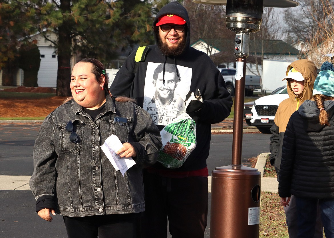 Anthony and Kyrstin Long pick up a turkey at the Turkeys and More distribution at Unity church on Friday.