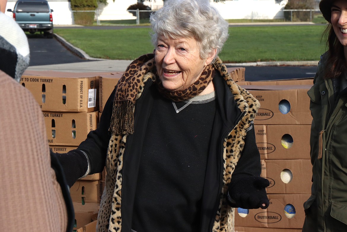 Evalyn Adams talks with volunteers during the Turkeys and More distribution on Friday.