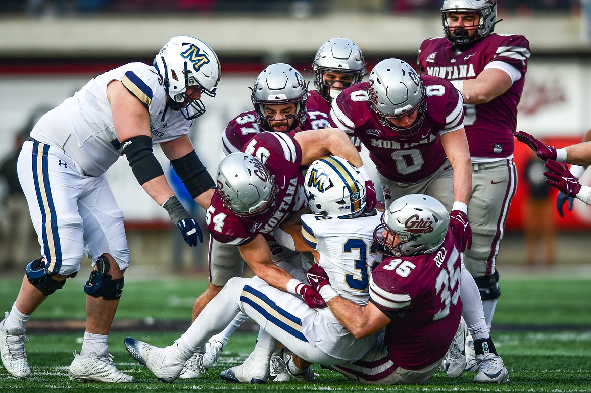 The Grizzlies defense puts a stop to a run by Montana State's Julius Davis (32) in the fourth quarter of the 122nd Brawl of the Wild at Washington-Grizzly Stadium on Saturday, Nov. 18. (Casey Kreider/Daily Inter Lake)