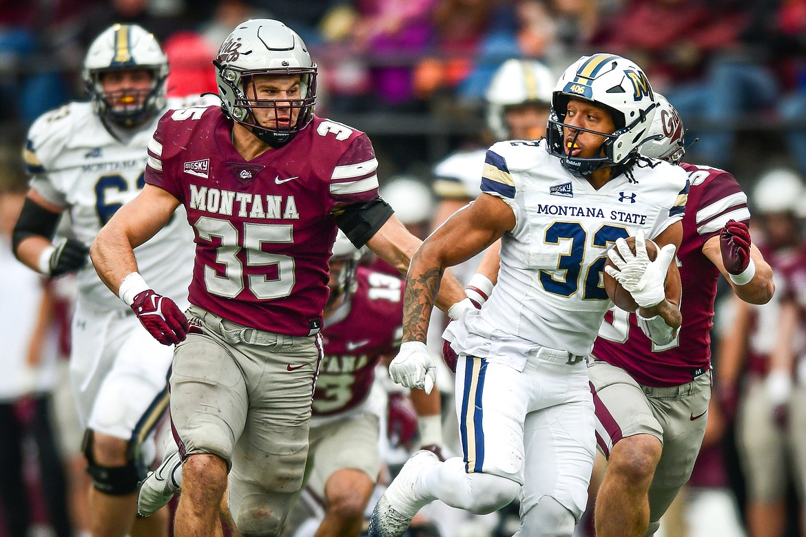 Bobcats running back Julius Davis (32) picks up yardage on a run in the third quarter against the Grizzlies in the 122nd Brawl of the Wild at Washington-Grizzly Stadium on Saturday, Nov. 18. (Casey Kreider/Daily Inter Lake)
