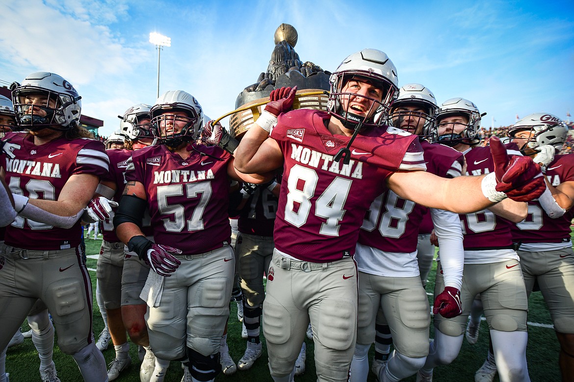The Grizzlies carry the Great Divide Trophy after a 37-7 victory over Montana State in the 122nd Brawl of the Wild at Washington-Grizzly Stadium on Saturday, Nov. 18. (Casey Kreider/Daily Inter Lake)