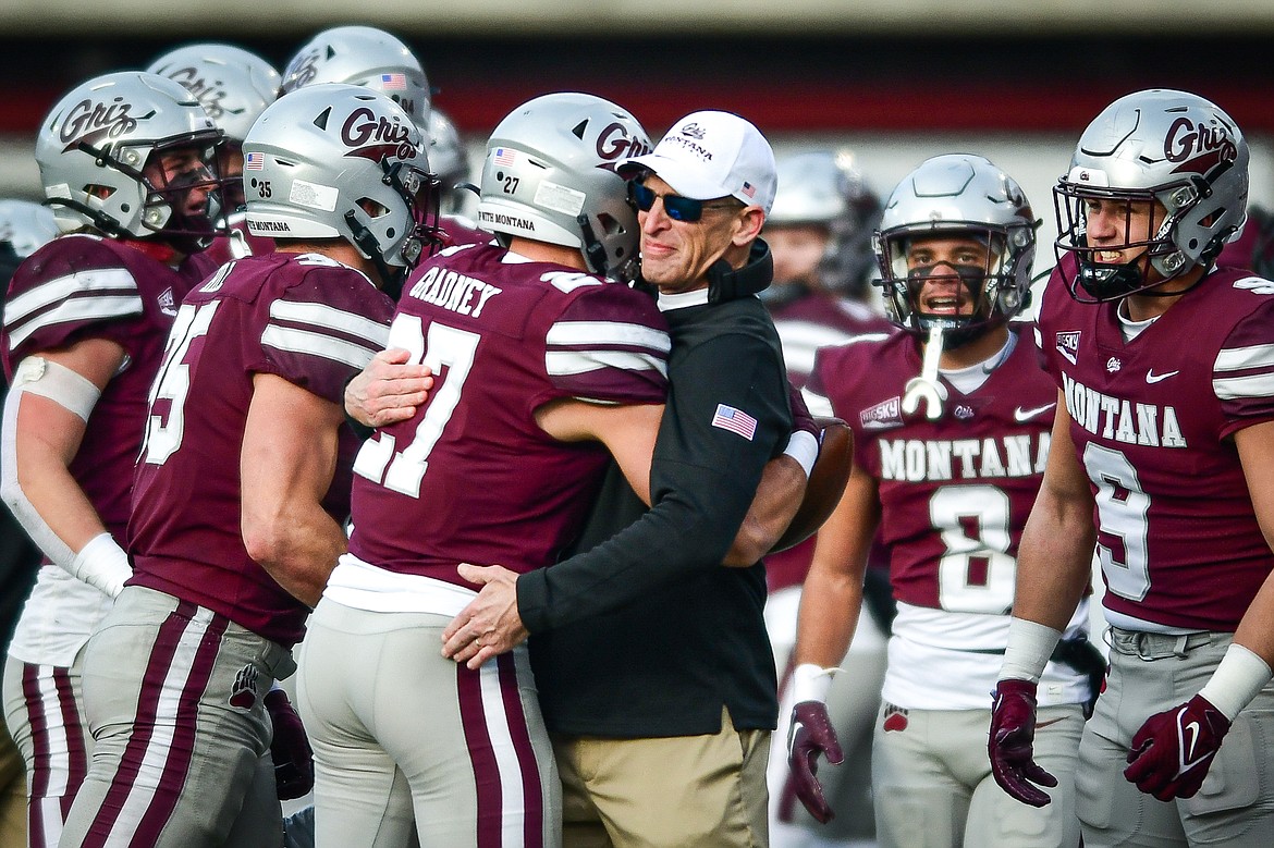 Montana head coach Bobby Hauck congratulates Trevin Gradney (27) and the defense after Gradney's interception in the fourth quarter against Montana State in the 122nd Brawl of the Wild at Washington-Grizzly Stadium on Saturday, Nov. 18. (Casey Kreider/Daily Inter Lake)