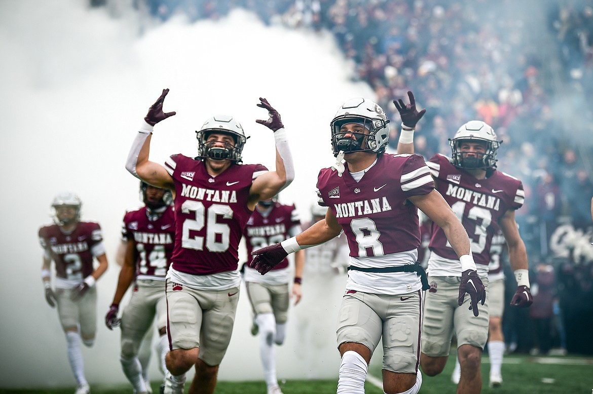 Nick Ostmo (26), Corbin Walker (8), Ryder Meyer (13) and the Montana Grizzlies take the field against Montana State for the Brawl of the Wild at Washington-Grizzly Stadium on Saturday, Nov. 18. (Casey Kreider/Daily Inter Lake)