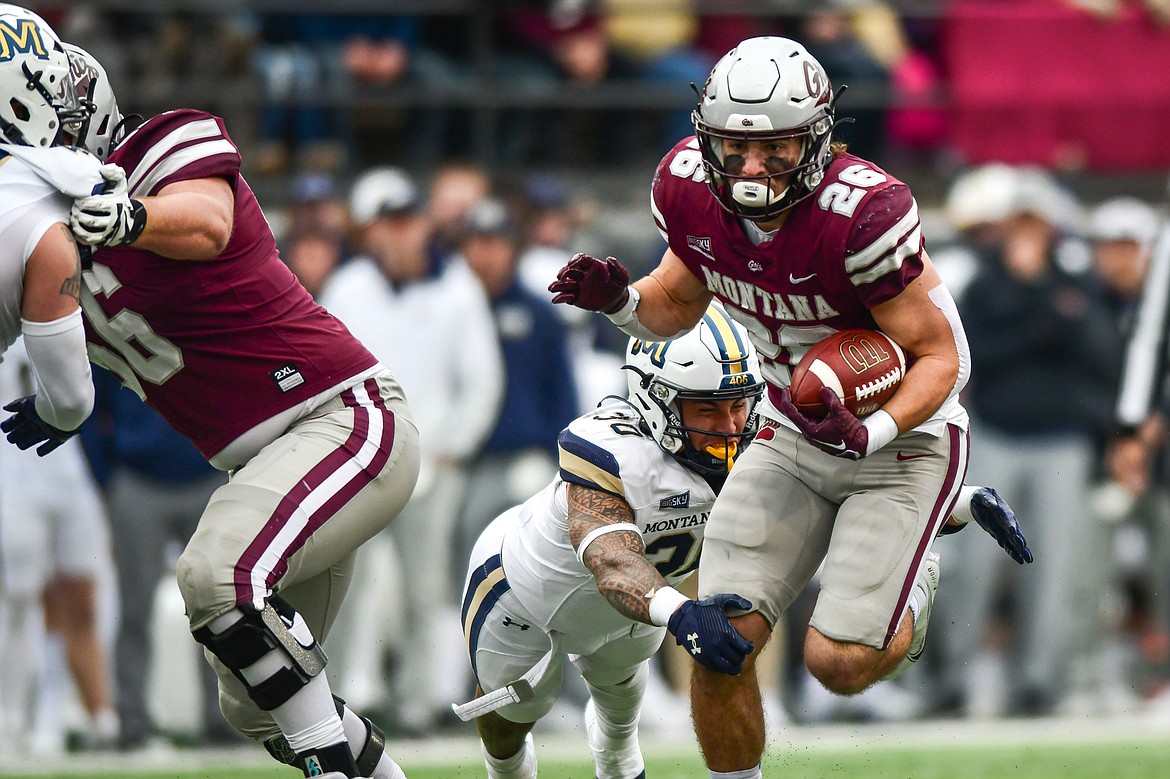 Grizzlies running back Nick Ostmo (26) picks up yardage on a run in the first quarter against Montana State in the 122nd Brawl of the Wild at Washington-Grizzly Stadium on Saturday, Nov. 18. (Casey Kreider/Daily Inter Lake)