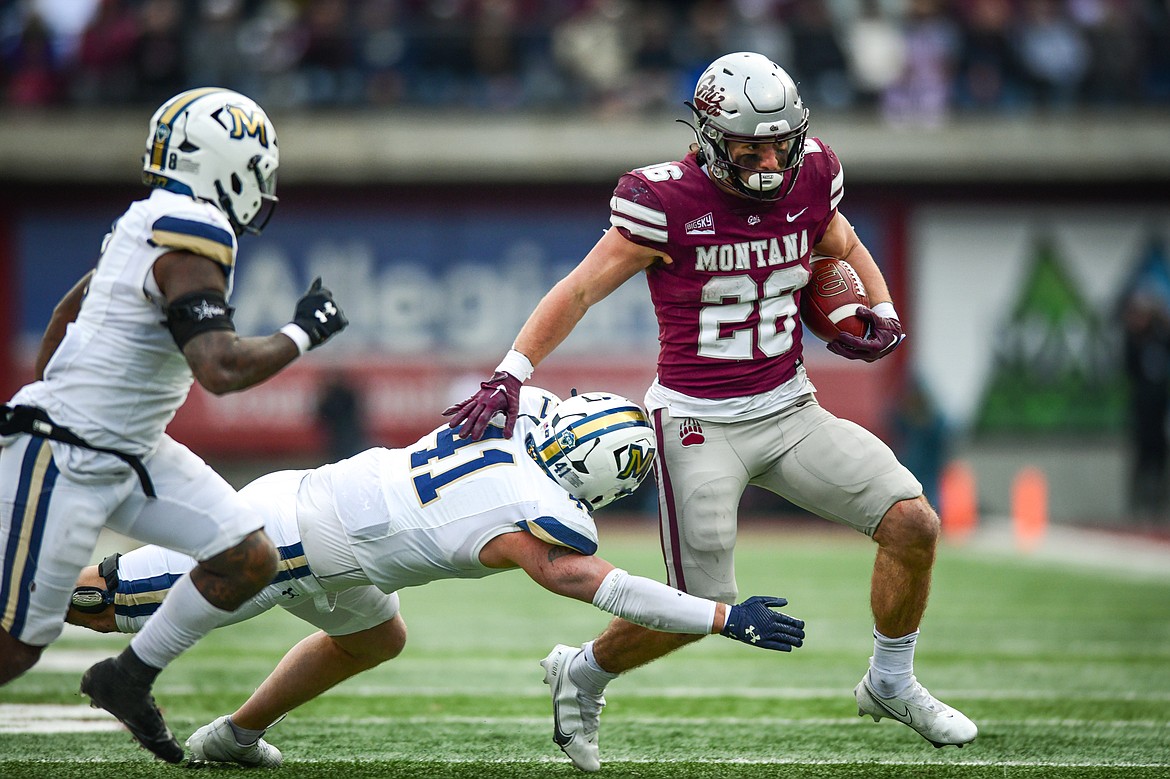 Montana running back Nick Ostmo (26) picks up yardage on a run in the third quarter against Montana State in the 122nd Brawl of the Wild at Washington-Grizzly Stadium on Saturday, Nov. 18. (Casey Kreider/Daily Inter Lake)
