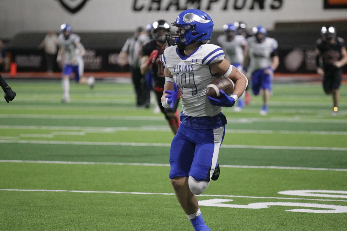 MARK NELKE/Press
Coeur d'Alene junior Kai Wheeler looks back as he races to the end zone to complete an 84-yard scoring pass from Joe Hagel in the first quarter against Highland at Holt Arena in Pocatello.