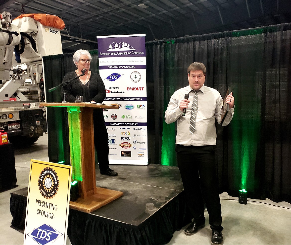 Emcee and Rathdrum Chamber board Vice President Suzanna Spencer presents Business of the Year to Russell Ward of Water Solutions on Saturday at the new Kootenai Electric Cooperative building in Rathdrum.