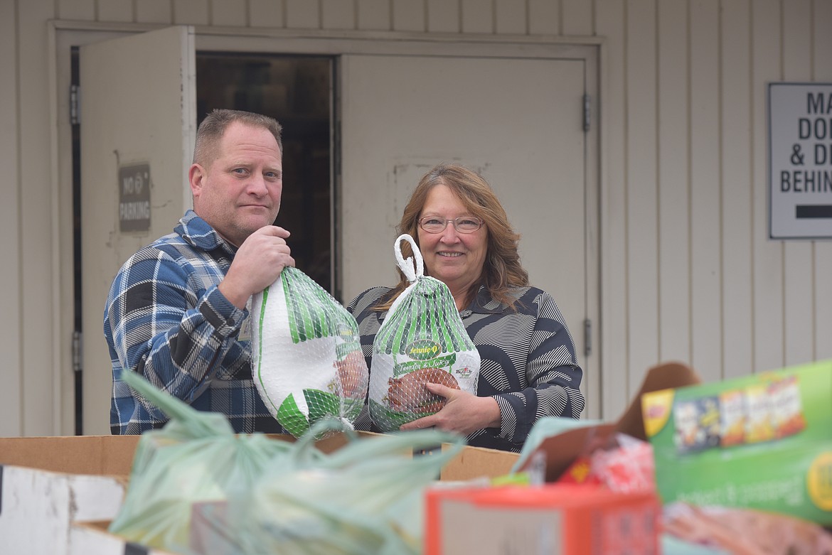 Cinnamon Davis-Hall, right, shows off turkeys donated to the Northwest Montana Veterans Food Pantry alongside Ryan Keeler, quartermaster of the Glacier Park Post 2252 of the Veterans of Foreign Wars, on Monday, Nov. 20, 2023. The pantry distributes Thanksgiving fixings to Flathead Valley veterans and their families. (Derrick Perkins/Daily Inter Lake)