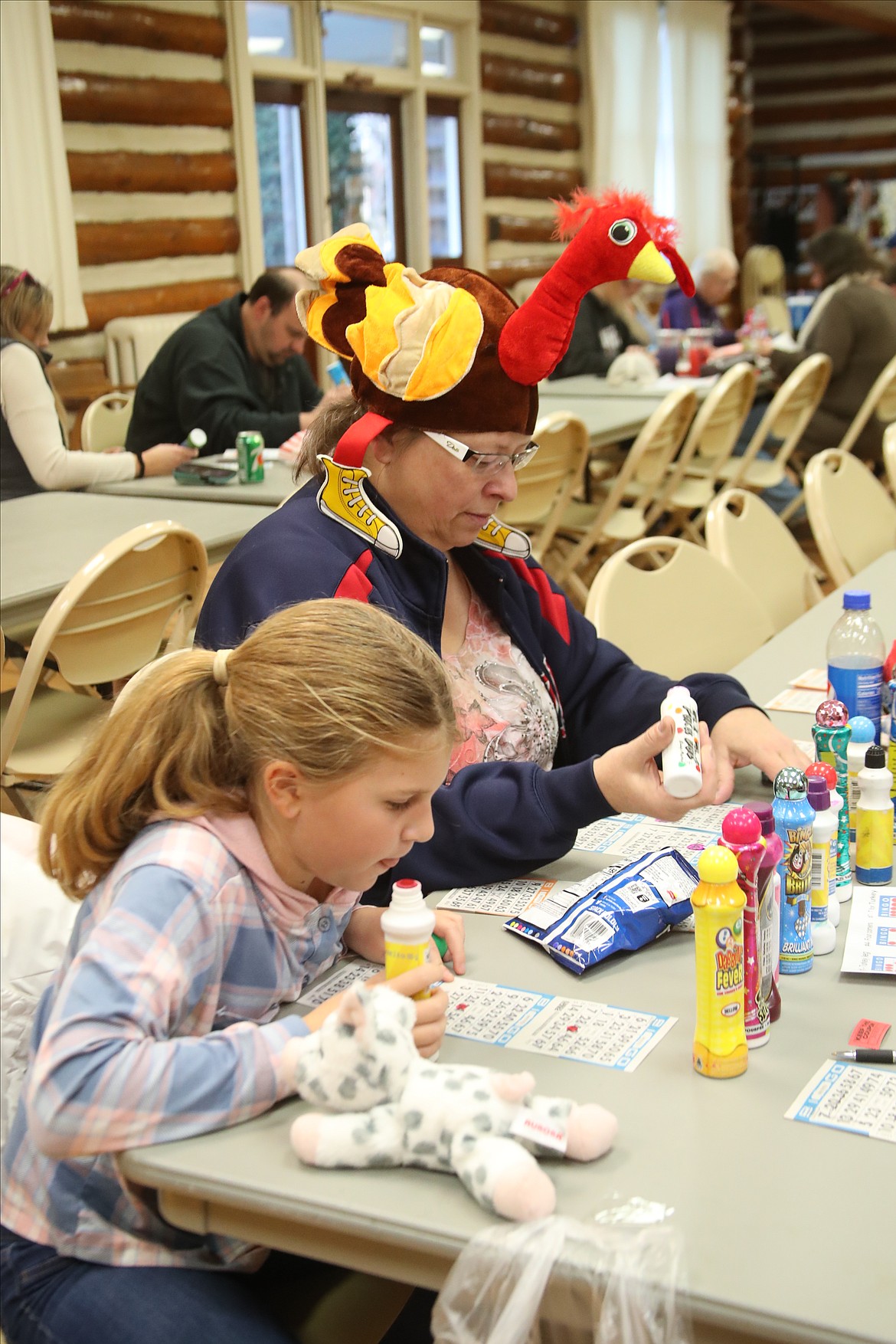 Khloe Schramm and Kathy Sauer checked to see if their bingo cards have the number called at the Sandpoint Lions' Turkey Bingo fundraiser on Saturday. The annual event is the traditional beginning of the Lions' annual Christmas drive, Toys for Tots.