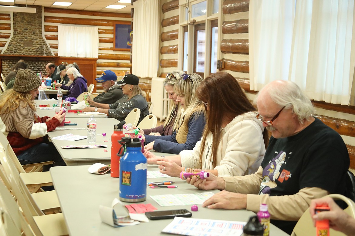 Bingo players check to see if they have the number called as they take part in the Sandpoint Lions Club'sTurkey Bingo fundraiser on Saturday. The annual event is the traditional beginning of the Lions' annual Christmas drive, Toys for Tots.