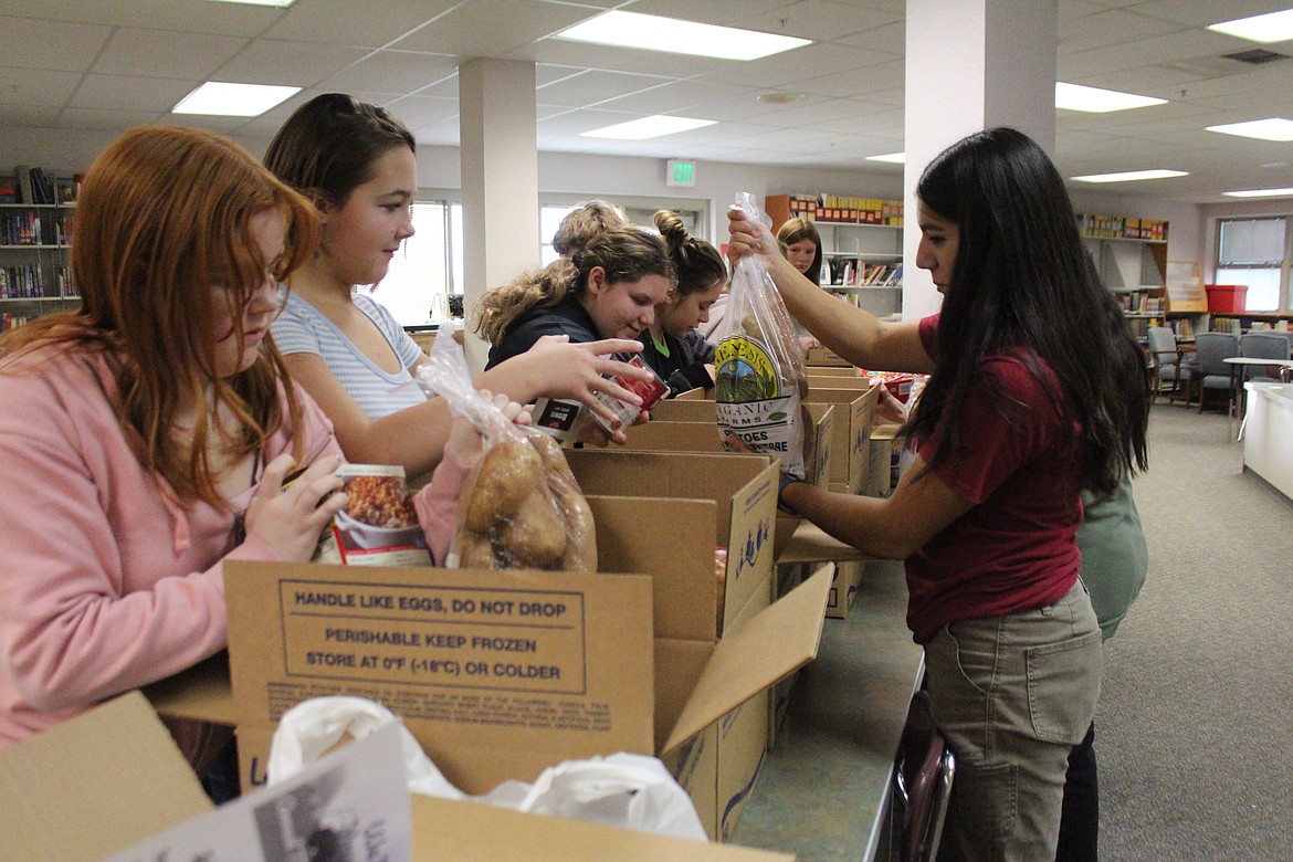 Columbia Middle School Builders Club and National Honor Society members and ASB leadership check out the donations gathered for Thanksgiving baskets that will go to CMS families.