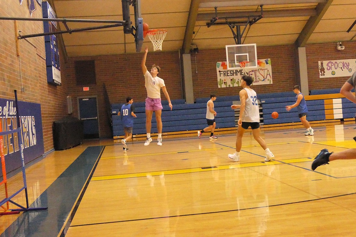 State wrestling champ Max Hannum, goes up for a layup during basketball practice last week with the Blue Hawks basketball team.  Hannum will participate in both sports this season for T Falls. (Chuck Bandel/VP-MI)