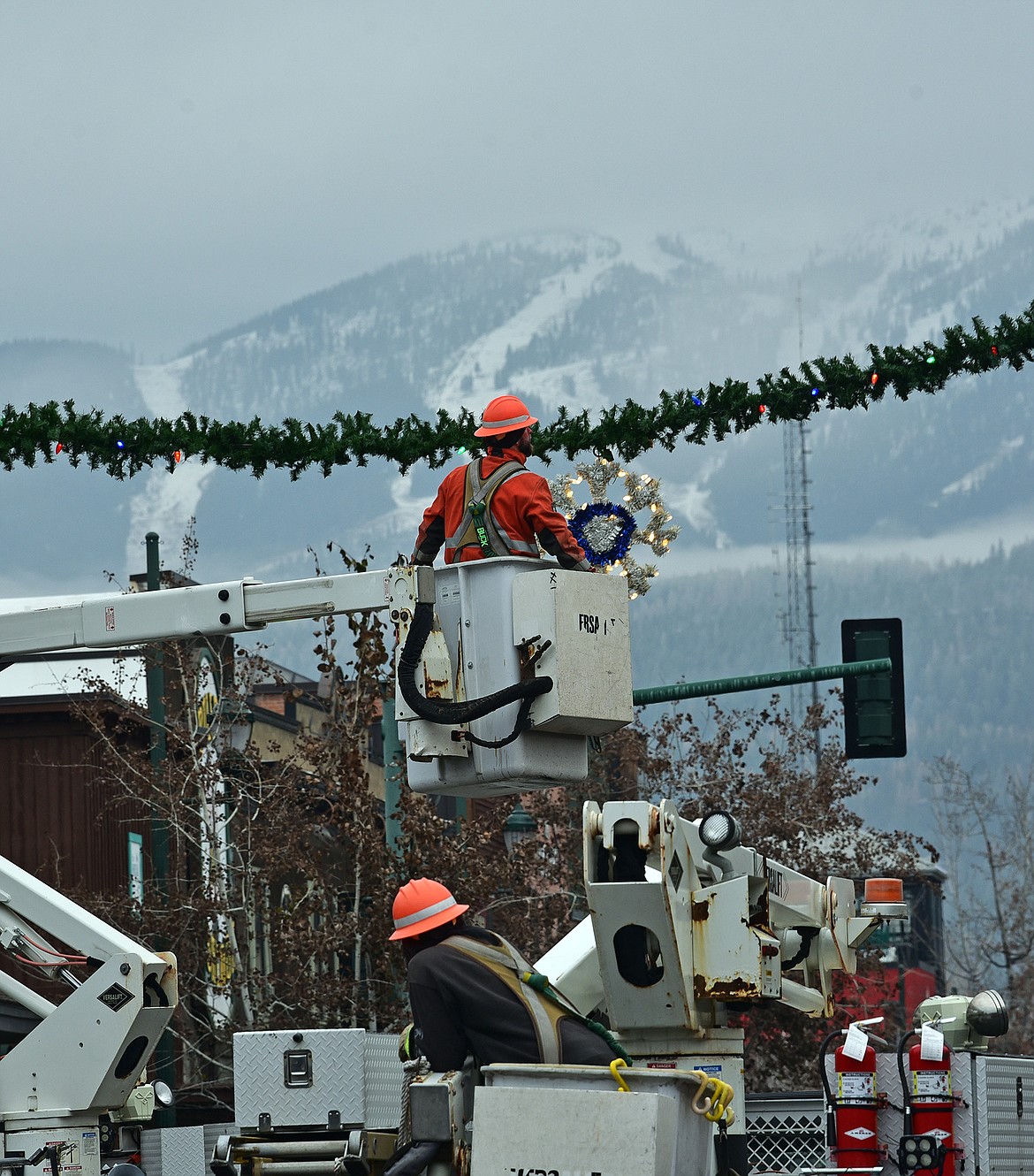 Flathead Electric Cooperative and several residents volunteered to put up Whitefish's winter decorations on Sunday. (Julie Engler/Whitefish Pilot)