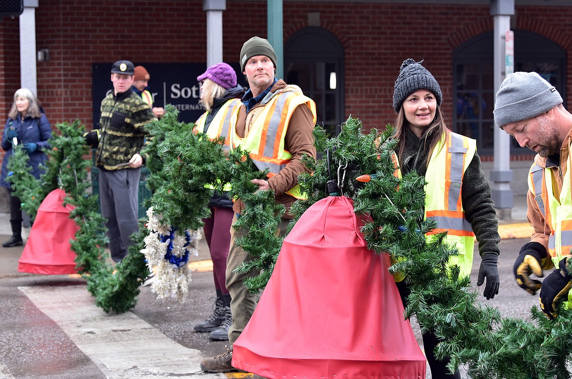 Flathead Electric Cooperative and several residents volunteered to put up Whitefish's winter decorations on Sunday. (Julie Engler/Whitefish Pilot)