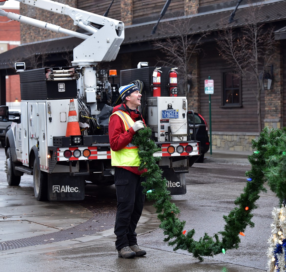 Flathead Electric Cooperative along with several residents volunteered to put up Whitefish's winter decorations on Sunday. (Julie Engler/Whitefish Pilot)