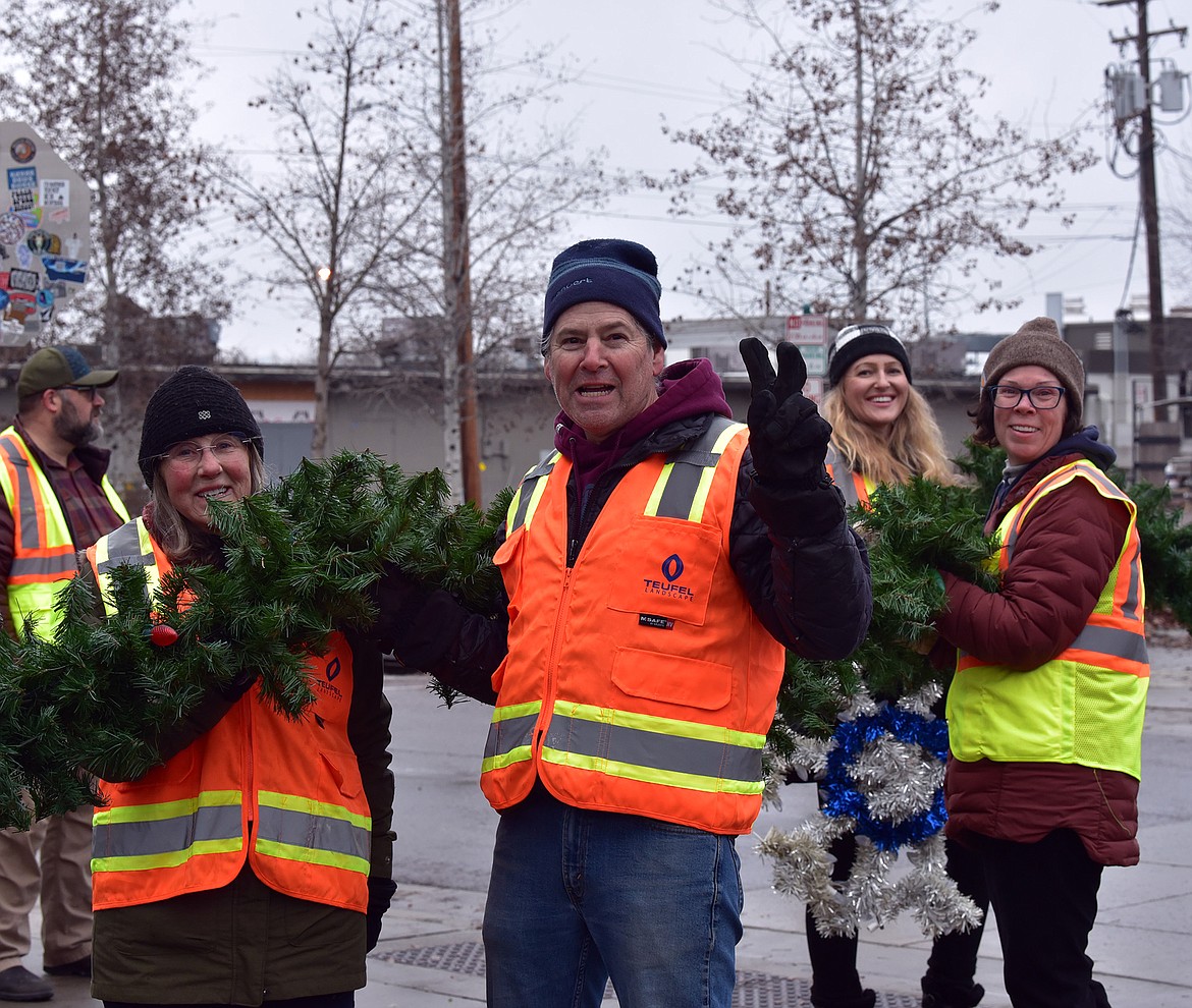 Flathead Electric Cooperative and several residents volunteered to put up Whitefish's winter decorations on Sunday. (Julie Engler/Whitefish Pilot)